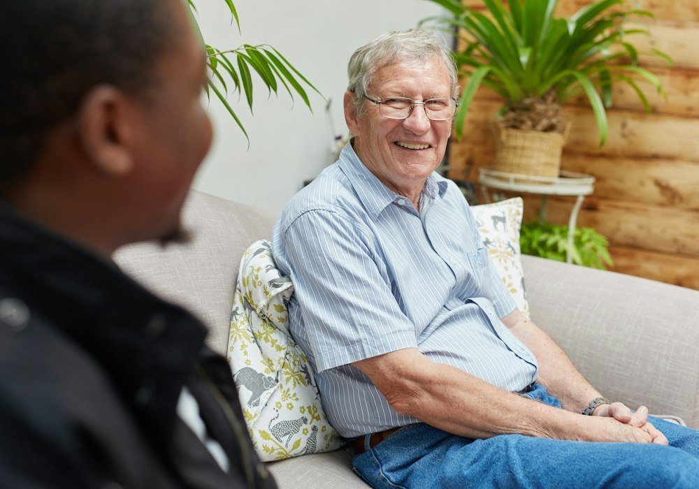 Friendly conversation with a smiling senior